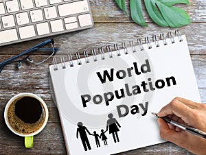 Top view with World Population Day text in notebook