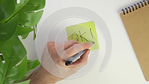 Top view write OK with a pen on a sticker. Put a colored piece of paper on your office desk and write a note with a