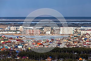 Top view of Yakutsk skyline with a lake in the evening