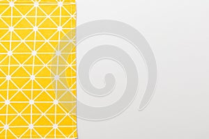 top view with yellow empty kitchen napkin isolated on table background. Folded cloth for mockup with copy space, Flat