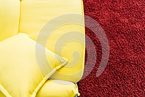 Top view of yellow leather couch and red