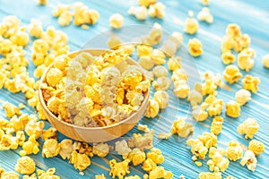 Top view yellow popcorn on blue wooden plank background