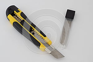 Top view of a yellow Snap-Off blade knife on a white background