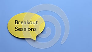 Top view of yellow speech bubble written with Breakout Sessions on blue background with copy space photo