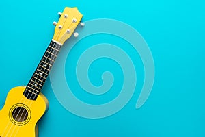 Top view of yellow ukulele with copy space