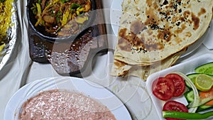 Top view of Yemeni food middle east cusine lamb kabsa bread salsa and soup