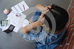 Top view of young asian woman trying to find money to pay off credit card debt