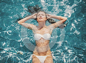 Top view. Young Beautiful Woman in Swimming Pool.