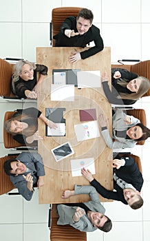 Top view. young business team sitting at a table and looking at the camera