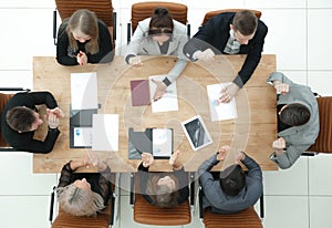Top view. young business team sitting at a table and looking at the camera