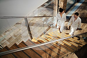 Top view of young couple in spa resort, walking up the stairs.