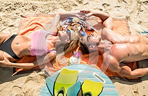 Top view of young couple vacationer having fun and relaxing on tropical Phuket beach in Thailand with coconut drink photo