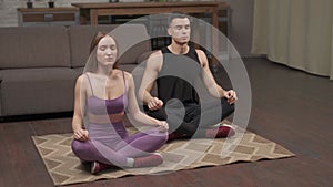 Top View Of Young Happy Caucasian Man And Woman Couple In Sportswear Doing Stretching yoga Exercise In Room At Home. Stay Home Qua