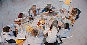 Top view young happy company employees analyse financial data chart at meeting, happy business woman giving directions.