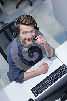 Male call centre operator doing his job top view