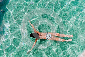 Top view of young woman diving underwater in a pool. summer and fun lifestyle