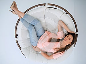 Top view.young woman relaxing in a comfortable chair