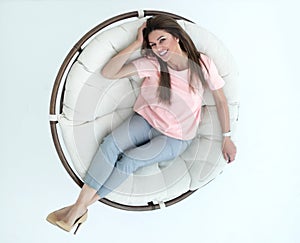 Top view.young woman relaxing in a comfortable chair