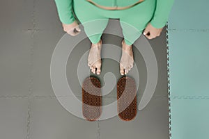 Top View of Young Woman Stepping on Nail Board in Yoga Studio