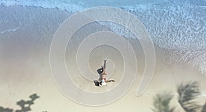 Top view of young woman sunbathing  in red bikini  freedom lifestyle and happy on the sand  beach during summer vacation concept