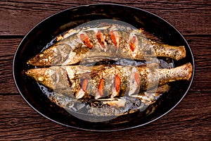 Top view zander fillet with tomatoes on frying pan photo