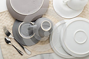 Top viewe of clean wet cups, plates, saucers, fork,spoon on the kithcen towel