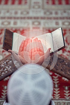 Top viewv of African Muslim Man Making Traditional Prayer To God While Wearing A Traditional Cap Dishdasha