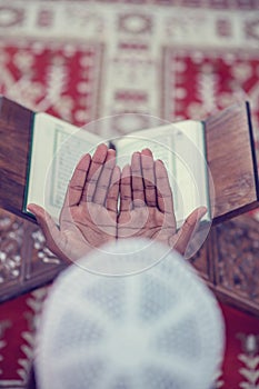 Top viewv of African Muslim Man Making Traditional Prayer To God While Wearing A Traditional Cap Dishdasha