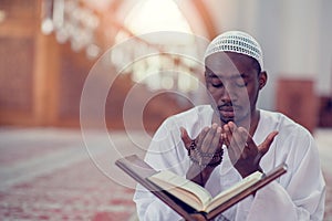 Top viewv of African Muslim Man Making Traditional Prayer To God While Wearing A Traditional Cap Dishdasha photo