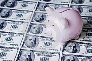 Top vieww of piggy bank onUS Dollar bills as symbol of business, wealth and power photo