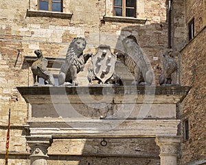 The top of The well of Griffins and Lions in the big square of Montepulciano, Italy.