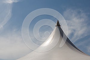 Top of white canvas tent under blue sky background