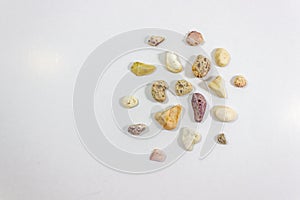 Top wide shot of several colorful stones that collected from beach on white background