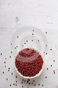 Top of wiev red peppercorn on white concrete board