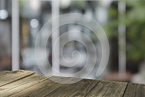 Top wood table Blur coffee shop or cafe restaurant with abstract bokeh light image background.