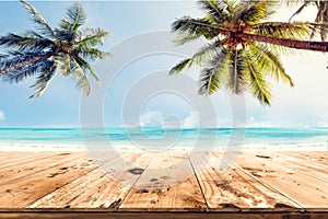 Top of wood table with blurred sea and coconut tree background