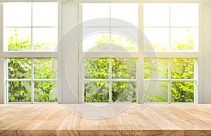 Top of wood table counter on blur window view garden background. photo