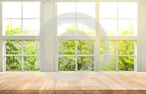 Top of wood table counter on blur window view garden background.