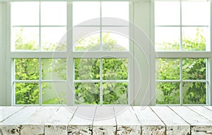 Top of wood table counter on blur window view garden background