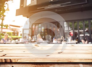 Top of wood table counter with blurred people in coffee shop