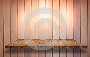 Top of wooden shelf with spot light on wooden wall background