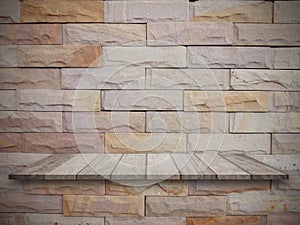 Top wooden shelves and stone wall background. product display on wood