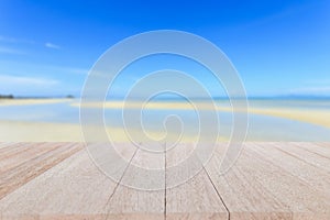 Top wooden table and blur of tropical beach background