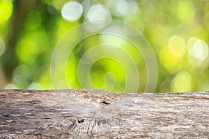 Top wooden table with sunny abstract green nature background, bl