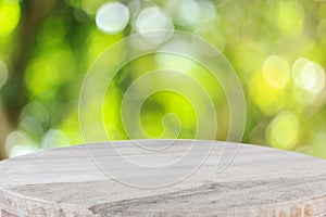 Top wooden table with sunny abstract green nature background, bl