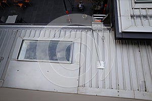 Roof top safety fall arrest anchor point plate permanently attached into first man up line photo