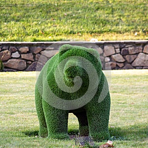 Topiary sculpture of a bear made of artificial grass