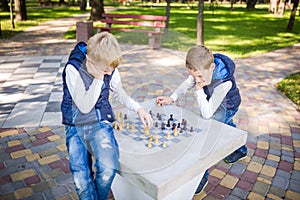 The topic is children learning, logical development, mind math, miscalculation moves advance. Big family two brothers Caucasian photo