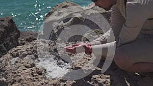 The topic is geology and research of crystals and rocks of natural origin. A male explorer takes samples of sea salt on