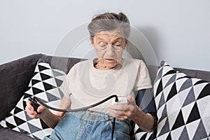 The topic is very old person and health problems. A senior Caucasian woman, 90 years old, with wrinkles and gray hair